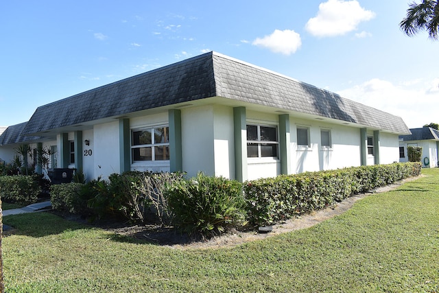 view of side of home with a yard