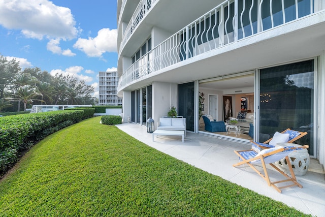 view of yard with a patio and a balcony