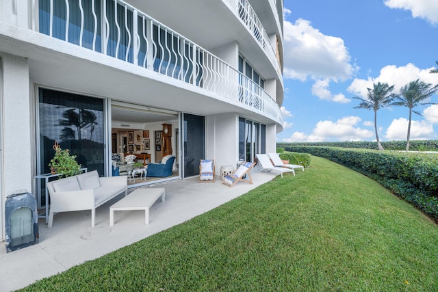 view of yard with a balcony and a patio