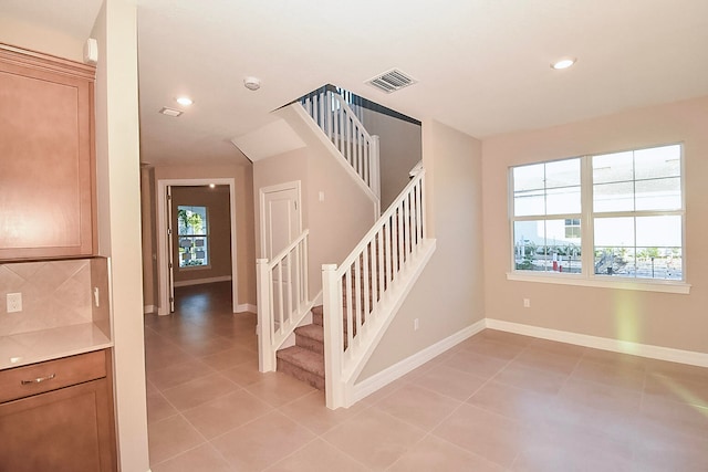 stairway with tile patterned flooring