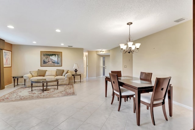 dining room featuring a chandelier and a textured ceiling