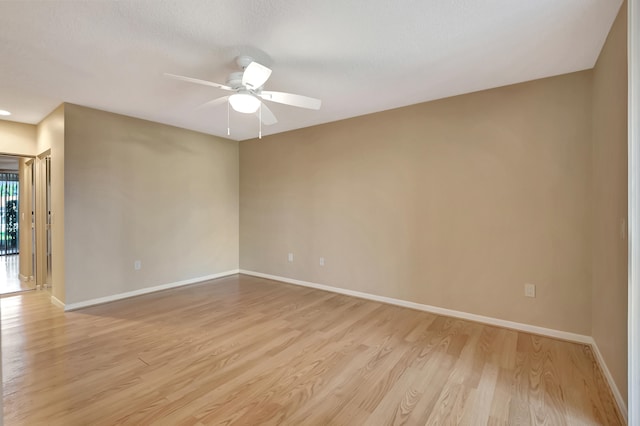 unfurnished room featuring ceiling fan and light wood-type flooring