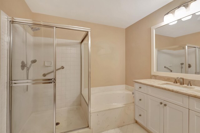 bathroom with vanity and independent shower and bath