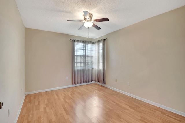 unfurnished room with ceiling fan, a textured ceiling, and light hardwood / wood-style flooring