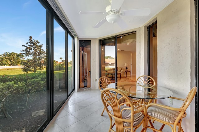 sunroom featuring ceiling fan