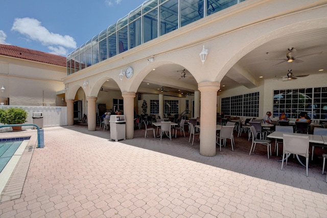 exterior space featuring a balcony, a pool, and ceiling fan