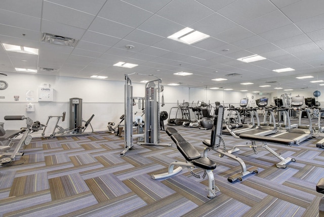 workout area with light colored carpet and a drop ceiling