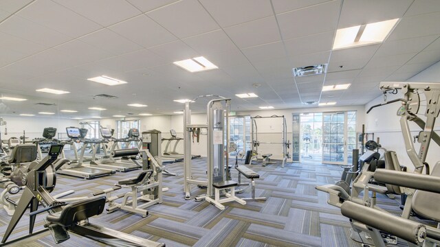 workout area with carpet flooring and a drop ceiling