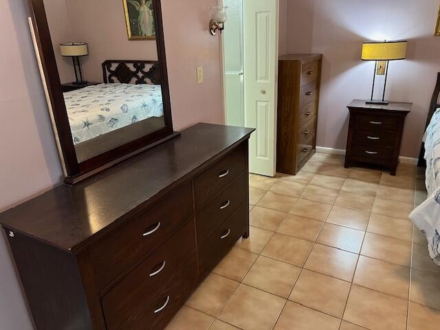 bedroom with light tile patterned floors