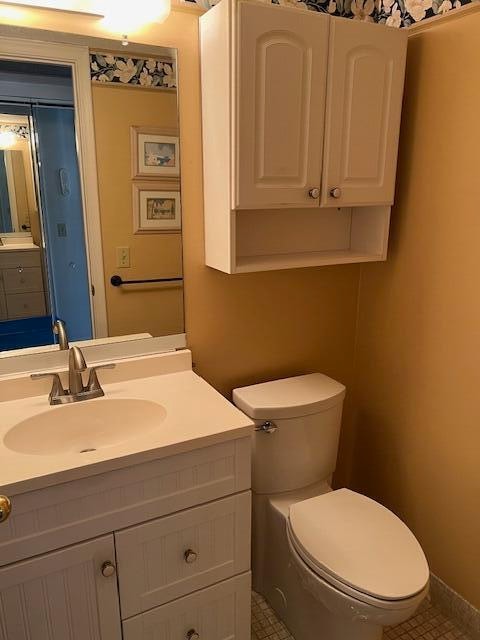 bathroom with vanity, toilet, and tile patterned flooring