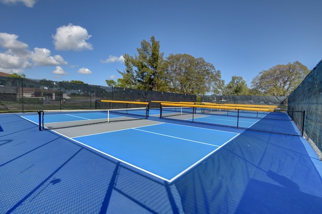 view of tennis court with basketball hoop