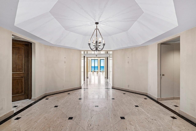 unfurnished dining area featuring an inviting chandelier