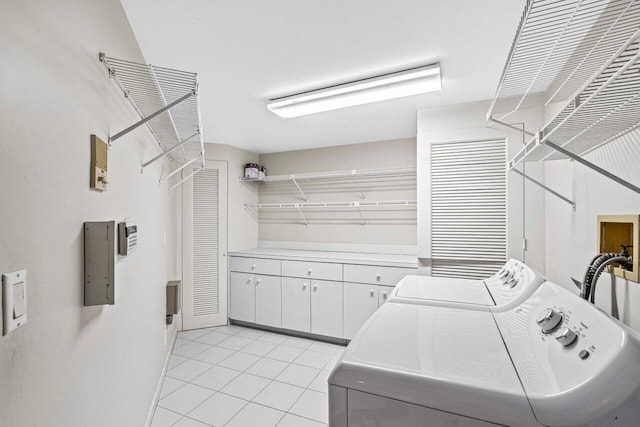 clothes washing area with washer and clothes dryer and light tile patterned floors