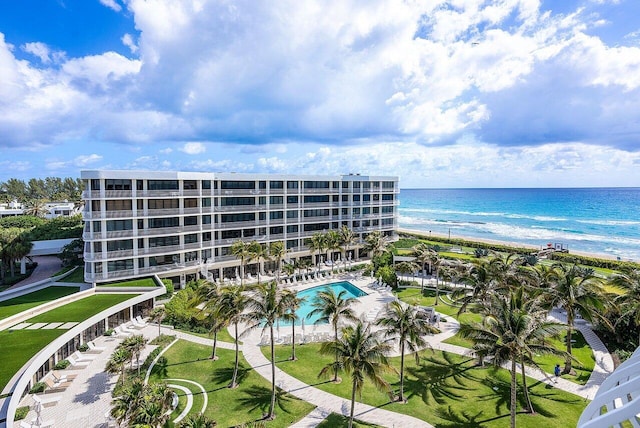 birds eye view of property with a water view and a beach view