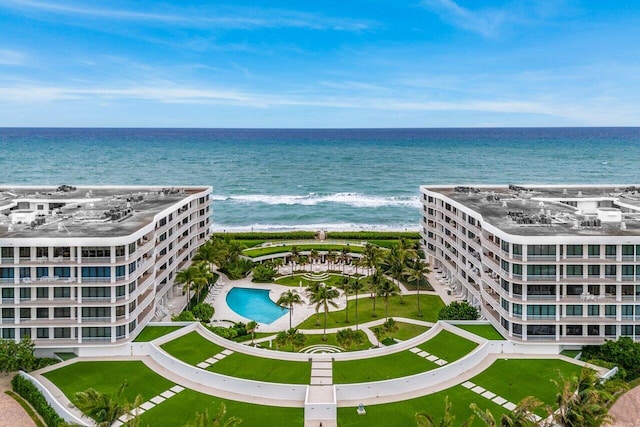 bird's eye view featuring a water view and a beach view