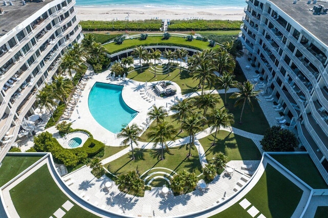 drone / aerial view featuring a water view and a beach view