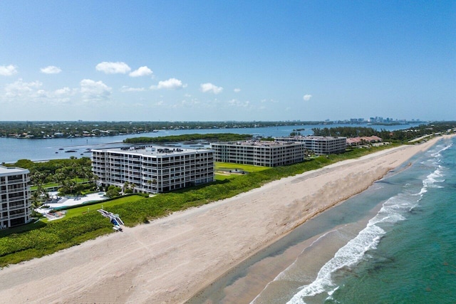 aerial view with a water view and a beach view