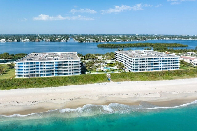 birds eye view of property featuring a water view and a beach view