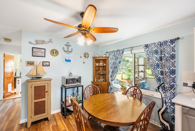 dining area featuring hardwood / wood-style floors and ceiling fan