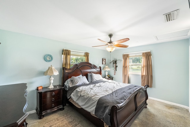 bedroom with ceiling fan and multiple windows