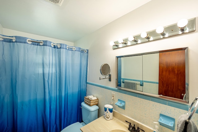 bathroom with vanity, a shower with curtain, and toilet