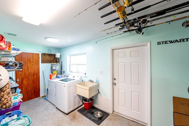 washroom with washer and dryer, electric water heater, and sink