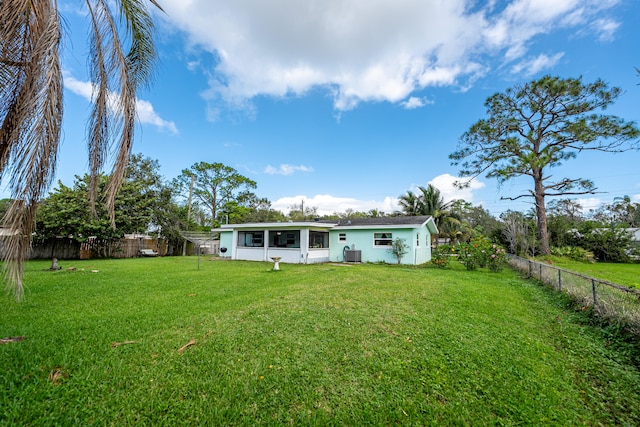 rear view of property with a yard