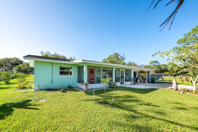 view of front of house with a patio area and a front yard