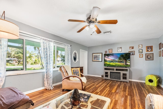 living room with ceiling fan, a healthy amount of sunlight, and dark hardwood / wood-style flooring