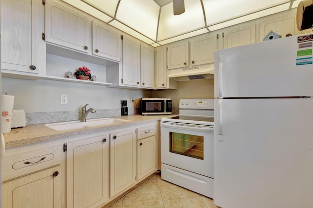 kitchen featuring sink, light tile patterned floors, and white appliances