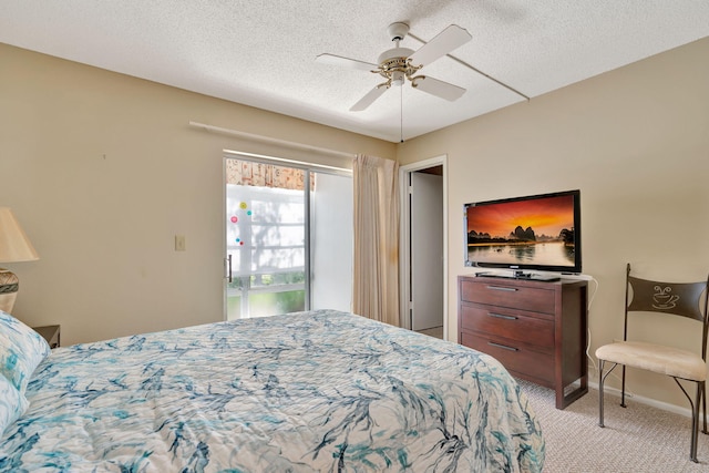 carpeted bedroom with a textured ceiling and ceiling fan