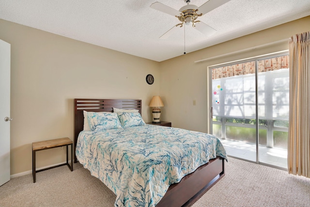 carpeted bedroom with a textured ceiling, access to outside, and ceiling fan