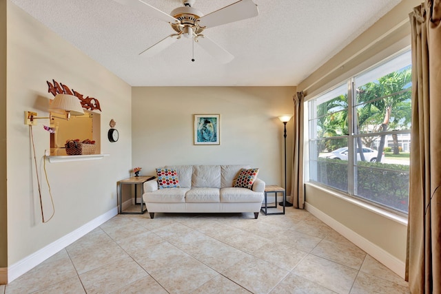 tiled living room with a textured ceiling and ceiling fan