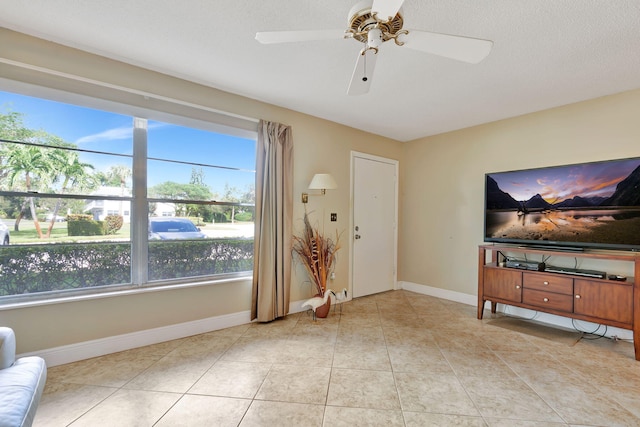 living room with plenty of natural light, light tile patterned flooring, and ceiling fan