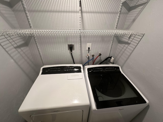 clothes washing area featuring independent washer and dryer