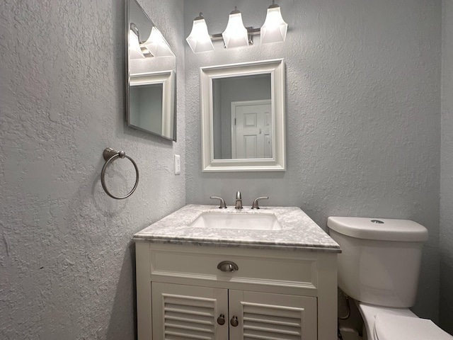9638 NW 65th St Unit C10, Tamarac, FL 33321 - half bathroom featuring a textured wall, toilet, and vanity