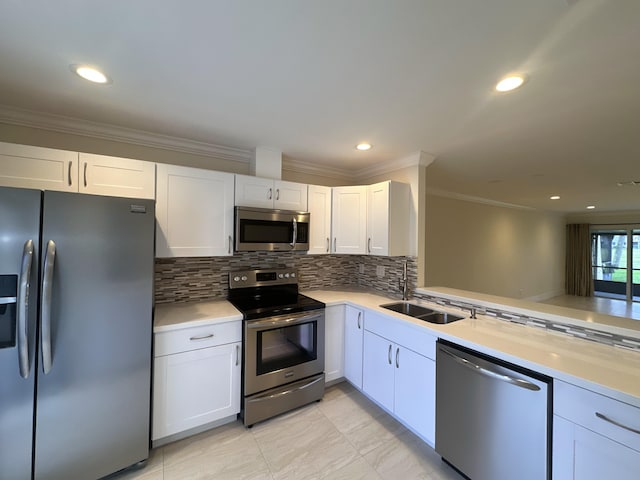 kitchen featuring sink, appliances with stainless steel finishes, and white cabinets