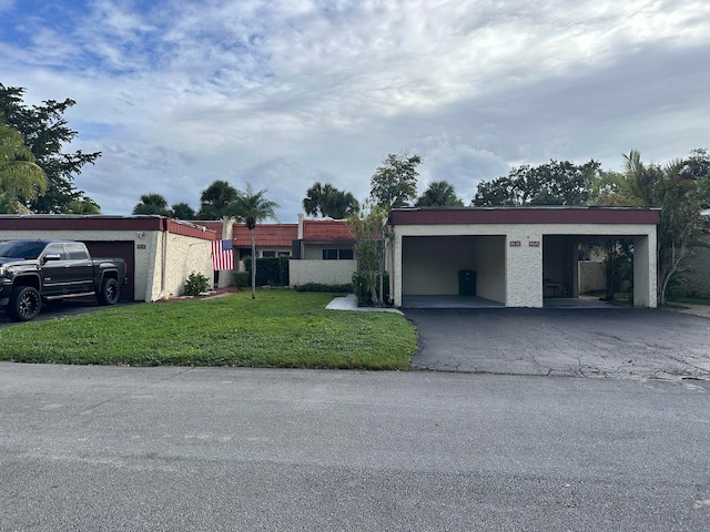 view of front facade with a front yard and a carport