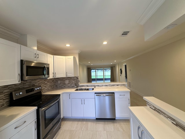 kitchen with sink, white cabinetry, decorative backsplash, and stainless steel appliances