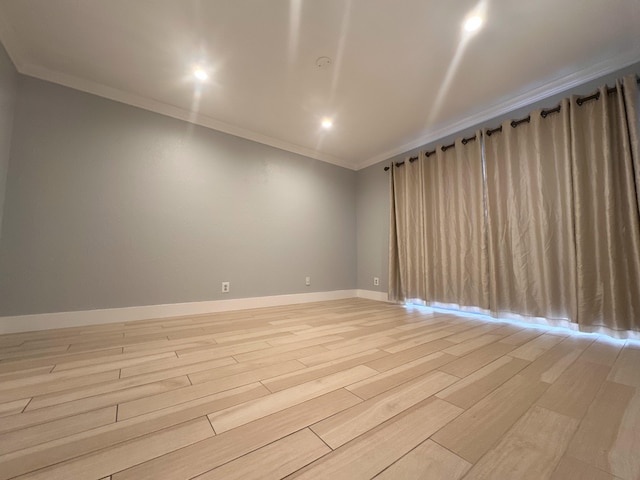 unfurnished room with crown molding and light hardwood / wood-style flooring