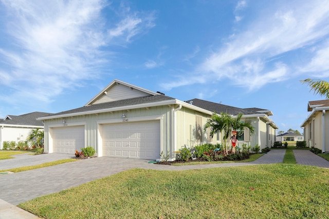 ranch-style home featuring a garage and a front lawn