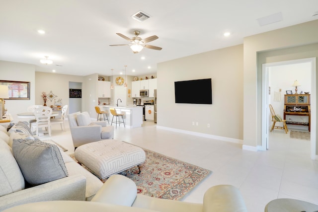 living room featuring sink and ceiling fan