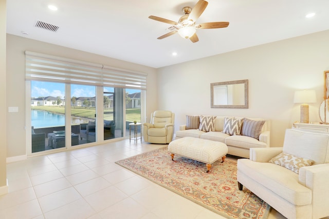 tiled living room featuring ceiling fan