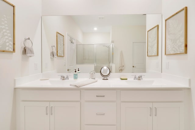 bathroom with vanity and a shower with shower door