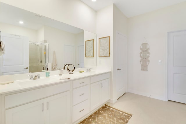 bathroom featuring vanity, an enclosed shower, and tile patterned floors