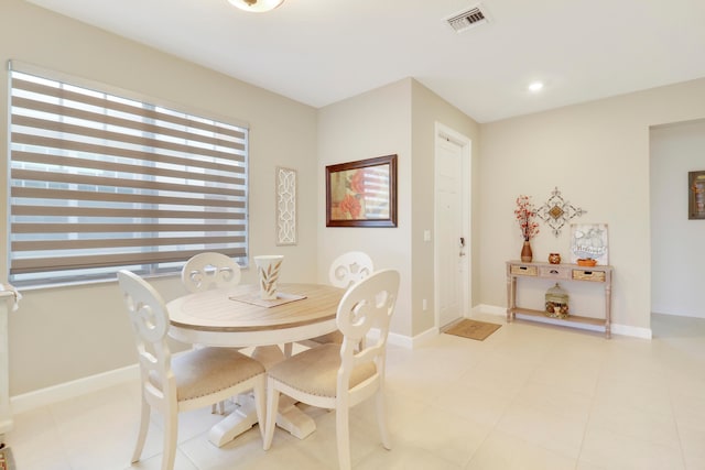 dining area with light tile patterned flooring