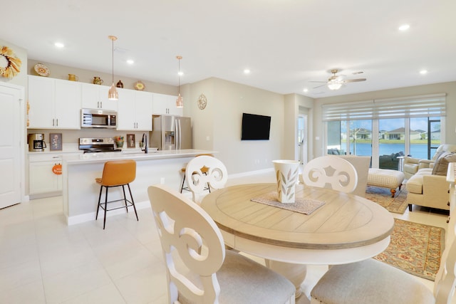 dining space with sink and ceiling fan