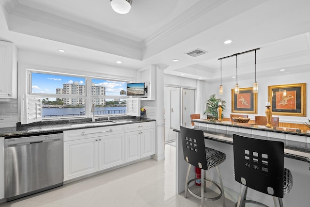 kitchen with dishwasher, tasteful backsplash, a tray ceiling, and white cabinets