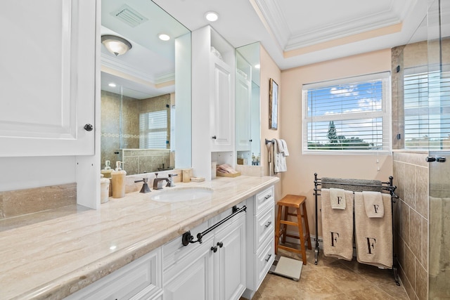 bathroom featuring tile patterned floors, crown molding, vanity, a raised ceiling, and a shower with shower door