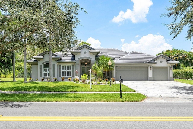 view of front facade with a garage and a front yard